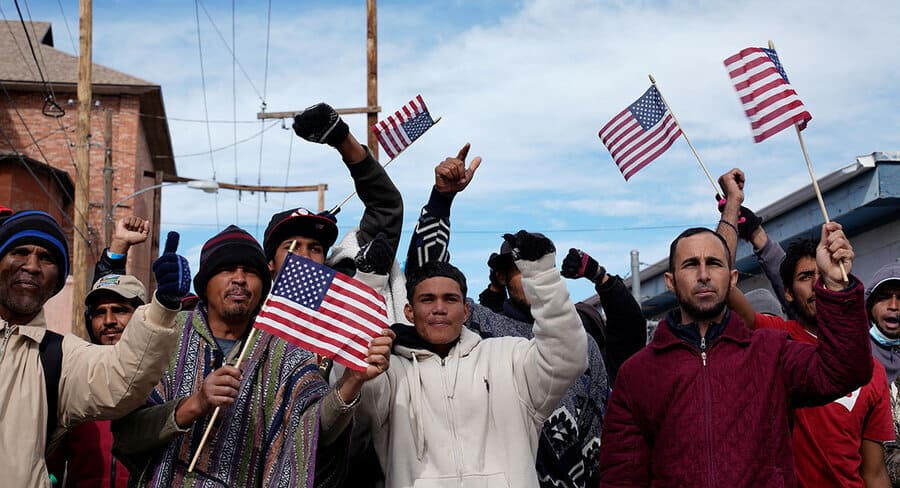 A group of immigrants holding US flags